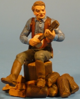 Cowboy Banjo spielend auf Baumstumpf