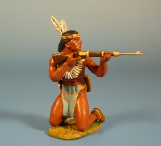 Indianer auf beiden Beinen kniend mit Gewehr schieend