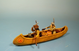 Trapper mit Indianerscout und Hund im Kanu